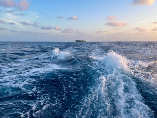 Boat trip at sunset. Sea foam after boat. Indian Ocean