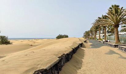 Desert comes to the city. Sandstorm in Maspalomas, seafront in dunes. Canary islands