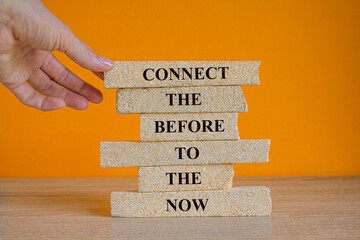 Connect the before to the now slogan written on brick blocks. Beautiful orange background, wooden...