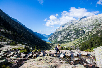 Young hiker woman in Vall de Boi, Aiguestortes and Sant Maurici National Park, Spain