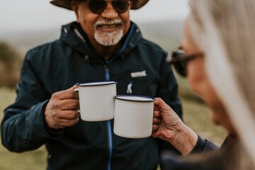 Senior camping couple drinking coffee