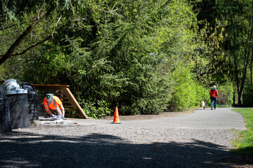 City parks workman grinding down concrete at the end of a bridge to level it off with the asphalt...