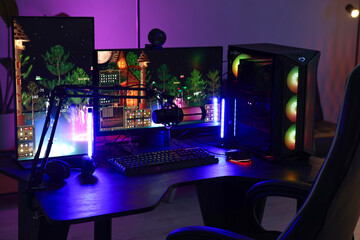 Playing video games. Stylish room interior with modern computer and gaming chair in neon lights