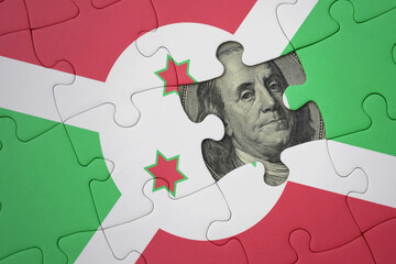 puzzle with the national flag of burundi and usa dollar banknote. finance concept