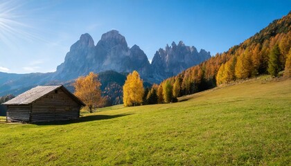 alpine meadows with barns in autumn dolomites italy