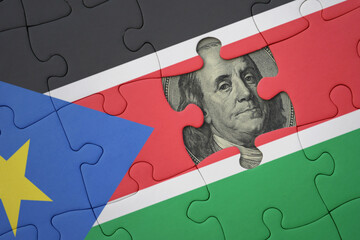 puzzle with the national flag of south sudan and usa dollar banknote. finance concept