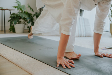 a woman wearing white clothes doing yoga moving, yoga at home