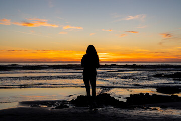 Fototapeta na wymiar woman at sunset on the beach