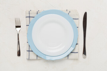 Minimal table setting on concrete background, top view