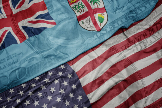 waving colorful flag of united states of america and national flag of Fiji on the dollar money background. finance concept. - Powered by Adobe