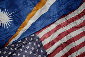 Obraz premium waving colorful flag of united states of america and national flag of Marshall Islands on the dollar money background. finance concept.