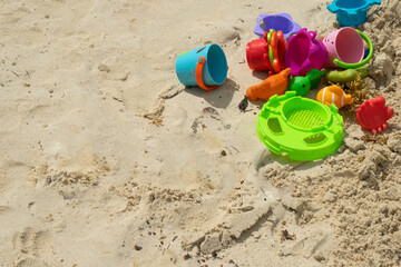 Colorful children's toys on the tropical beach, suggesting playful activity and family fun under the sun.During the vacations, in Tulum, Mexico.