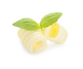 Tasty butter curls and basil leaves isolated on white