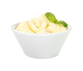 Tasty butter curls and basil leaves in bowl isolated on white