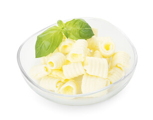 Tasty butter curls and basil leaves in bowl isolated on white