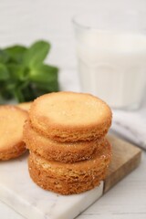 Tasty sweet sugar cookies on white wooden table, closeup