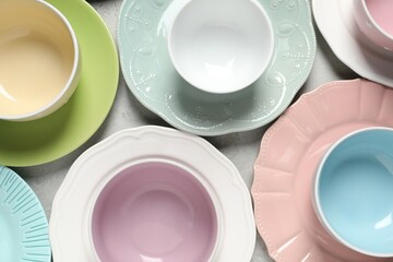 Beautiful ceramic dishware on light grey table, flat lay