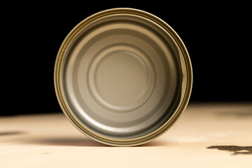 an open round can for canning on a wooden table