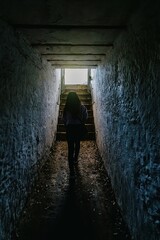 Woman walking through a WWii tunnel in North Head, Devonport, Auckland, New Zealand.