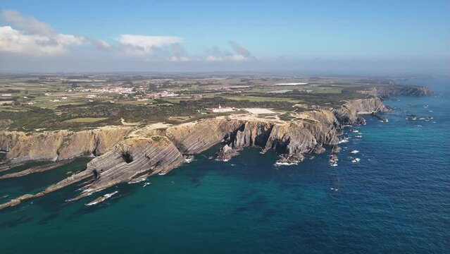 Aerial footage of the Farol do Cabo Sardao a lighthouse at the western coast of Portugal
