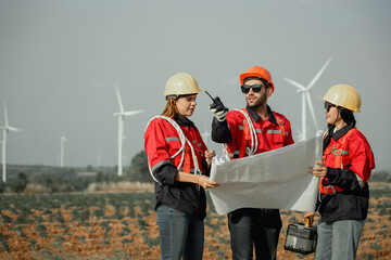 Young man and woman maintenance engineer team. two engineer operate wind turbine. Engineer and worker discussing on a wind turbine farm. Wind Turbine. Maintenance Workers. renewable energies.. - obrazy, fototapety, plakaty