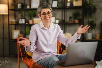 Mature woman with eyeglasses have video call with dear person at home