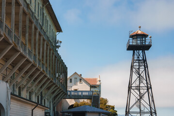Historic scene at Alcatraz prison in San Francisco, USA. Shows old prison building, watchtower for...
