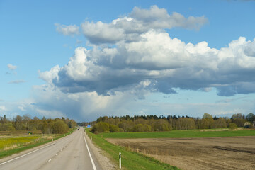 Fototapeta premium Endless Road Under Dynamic Cloud Formation