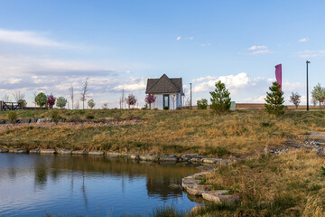Beautiful spring landscape with a pond and reflections in the small neighborhood park in Aurora, Colorado