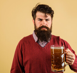 Beer time. Serious man with beard and mustache drinking beer in pub or bar. Alcohol. Stylish...