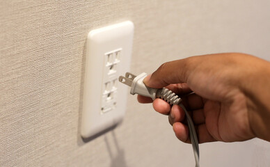 Hand insert a plug into socket.