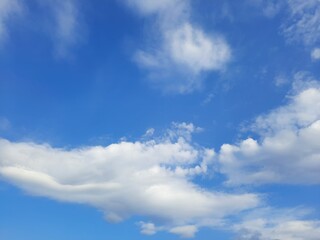 Naklejka na ściany i meble Beauty cloud against a blue sky background. Sky slouds. Blue sky with cloudy weather, nature cloud. White clouds, blue sky and sun. High quality photo