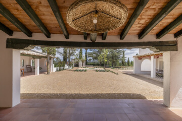 a gallery with wooden ceilings in the patio of an Andalusian farmhouse style house