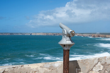 Sightseeing tourist coin operated telescope at watching point with scenic view in Algarve, Portugal