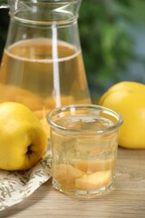 Delicious quince drink and fresh fruits on wooden table