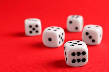 Many white game dices on red background, closeup