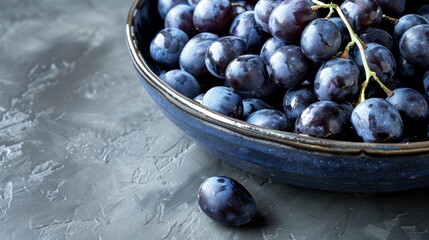 Delicious fresh plump purple grapes in a bowl