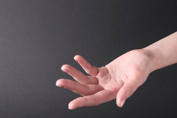 Woman holding hand on black background, closeup. Space for text