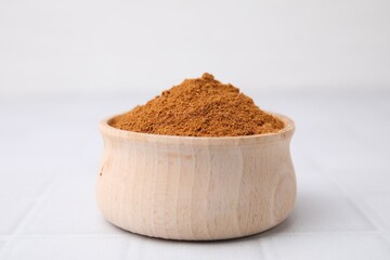 Ground red pepper on white tiled table, closeup