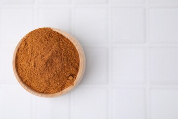 Ground red pepper on white tiled table, top view. Space for text