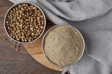 Ground pepper and peppercorns on wooden table, flat lay