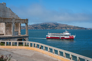 Explore the views of Alcatraz Island with a faded structure and a modern ferry on the San Francisco...