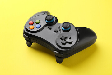 One wireless game controller on yellow background