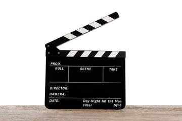 Movie clapper on wooden table against white background