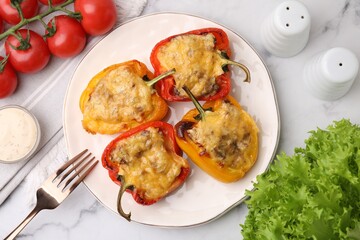 Delicious stuffed peppers served on white marble table, flat lay