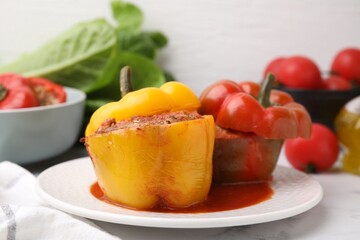 Delicious stuffed bell peppers served on white marble table