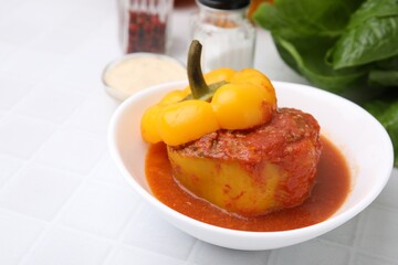 Delicious stuffed bell pepper on white tiled table. Space for text