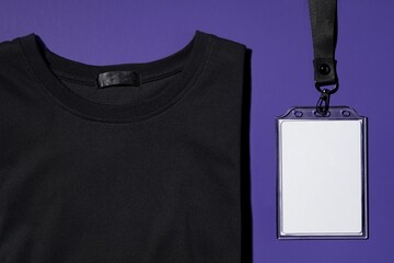 Black t-shirt, next to white ID holder, corporate identity design
