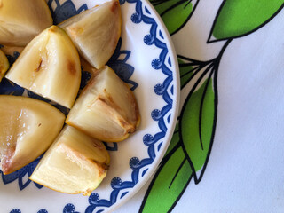 Abiu fruit cut into pieces on white porcelain plate with blue details