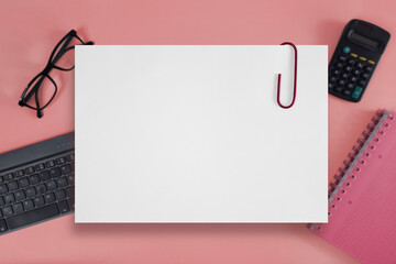Blank sheet of paper. Empty white page with paper clip on blurred background of business...